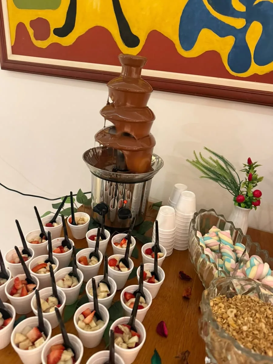 Fonte de chocolate e copinhos de frutas na mesa do evento — evento corporativo do Buffet Big House